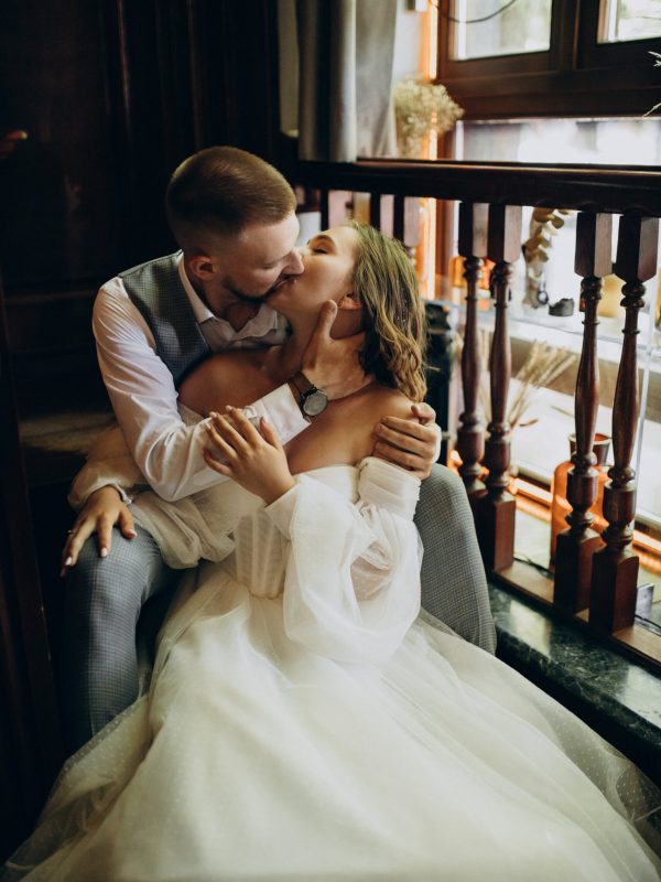 WEdding couple on their wedding having photoshoot in a cafe